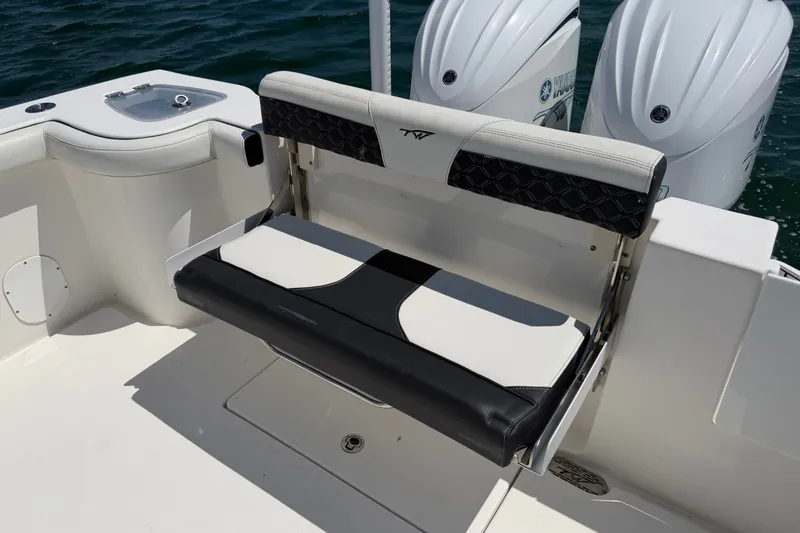 Slide: The Image of 2023 Tidewater 292 CC Adventure boat seat with dual engines in background. - 21