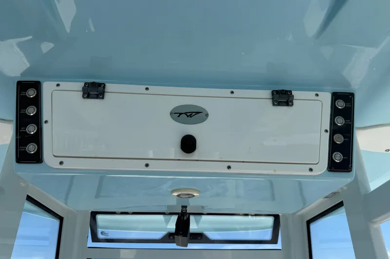 Slide: The Image of 2023 Tidewater 292 CC Adventure boat console with control panel and storage compartment. - 14