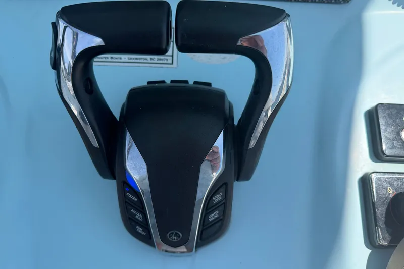 Slide: The Image of Close-up of a modern boat throttle with sleek details and multiple buttons. - 9