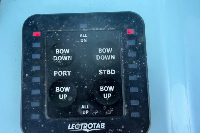 Slide: The Image of A control panel with buttons for bow and starboard trim on a Tidewater 292 CC Adventure. - 11