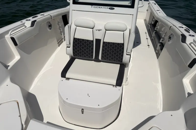 Slide: The Image of 2023 Tidewater 292 CC Adventure boat interior with cushioned seating and sleek design. - 17