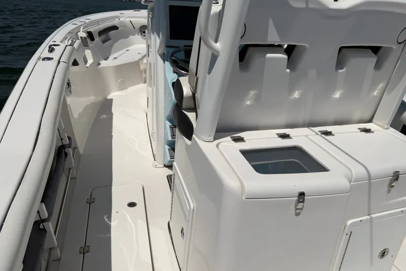 Slide: The Image of 2023 Tidewater 292 CC Adventure boat interior with seating and storage compartments. - 24