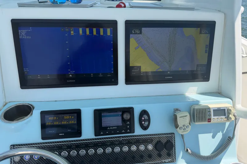 Slide: The Image of 2023 Tidewater 292 CC Adventure dashboard with Garmin navigation displays and marine electronics. - 7