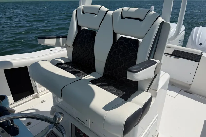 Slide: The Image of Luxury seating on 2023 Tidewater 292 CC Adventure boat, featuring comfortable dual captain's chairs. - 19