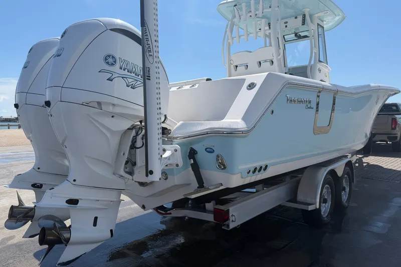 Slide: The Image of 2023 Tidewater 292 CC Adventure boat with dual Yamaha engines on a trailer. - 5