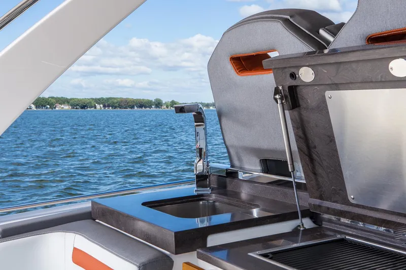 Slide: The Image of Manufacturer Provided Image: 2022 Tiara Yachts 38 LS boat with outdoor kitchen and sink, overlooking serene lake. - 6