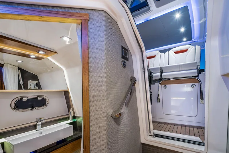 Slide: The Image of Manufacturer Provided Image: 2022 Tiara Yachts 38 LS interior, featuring modern bathroom and stylish seating area. - 12