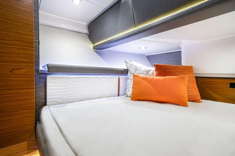 Slide: The Image of Manufacturer Provided Image: 2022 Tiara Yachts 38 LS cabin interior with modern bedding and orange pillows. - 11