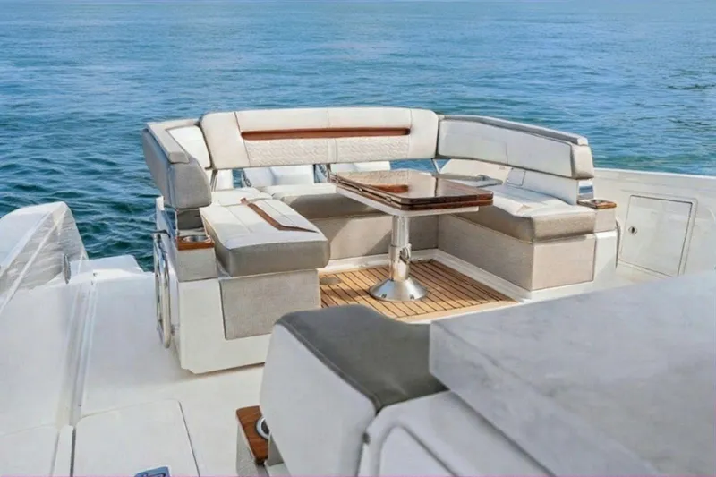 Slide: The Image of Luxurious seating area on 2022 Tiara Yachts 38 LS, overlooking serene ocean waters. - 4