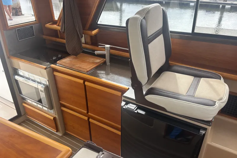 Slide: The Image of Interior of 2016 Cutwater C-28 boat with Galley and companion seating above dual voltage refrigerator - 25