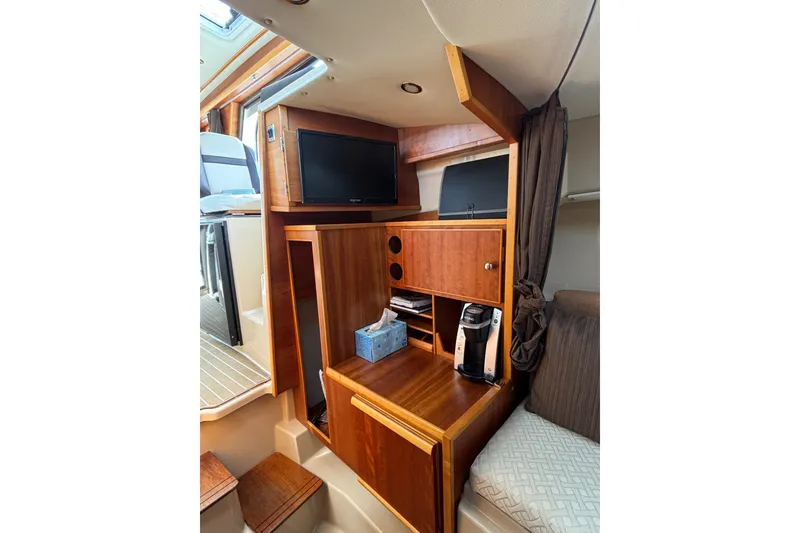 Slide: The Image of Interior of 2016 Cutwater C-28 forward stateroom cabinetry, hanging locker, and 19" Flatscreen TV - 35