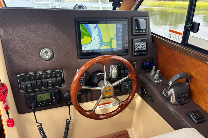 Slide: The Image of 2016 Cutwater C-28 helm with Garmin GPS/Radar/Sonar, Garmin Auto Pilot, Garmin VHF Radio, Bow and Stern Thruster joysticks, Volvo Electronic Engine Control and trim tab controls - 41