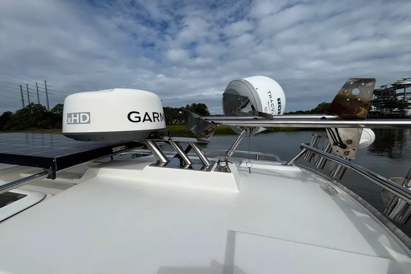 Slide: The Image of 2016 Cutwater C-28 hardtop roof with Garmin 4kw radar dome, KVH Sat TV Dome and folding stainless steel mast - 20