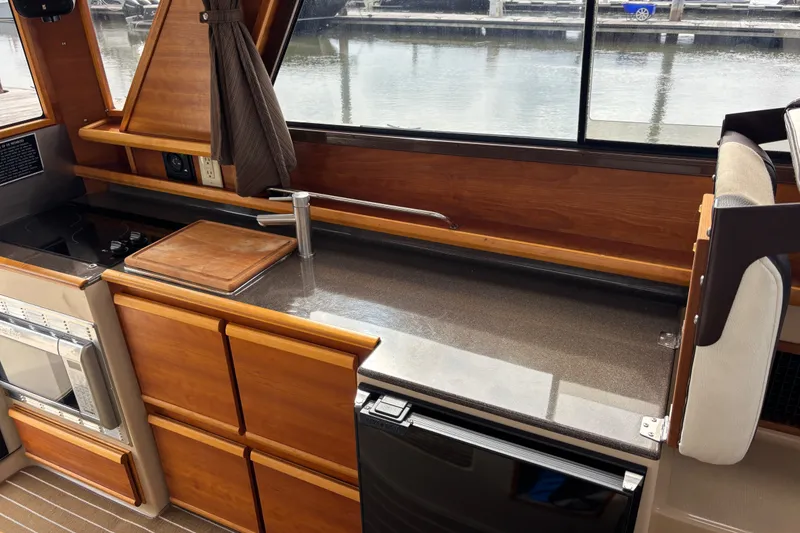 Slide: The Image of 2016 Cutwater C-28 Galley with companion seat flipped up to provide more counter space - 28