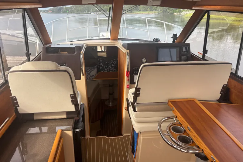 Slide: The Image of Interior view of a 2016 Cutwater C-28 boat, featuring seating and navigation equipment. - 27