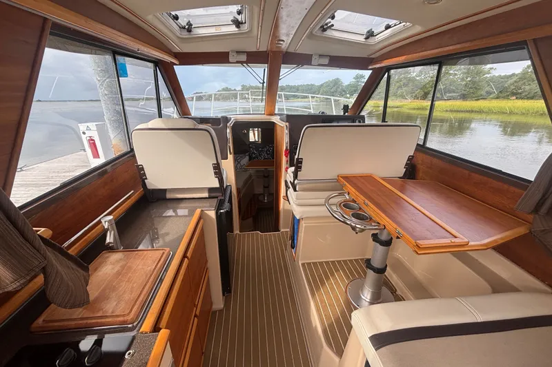 Slide: The Image of Interior of a 2016 Cutwater C-28 boat with wood accents and seating. - 22
