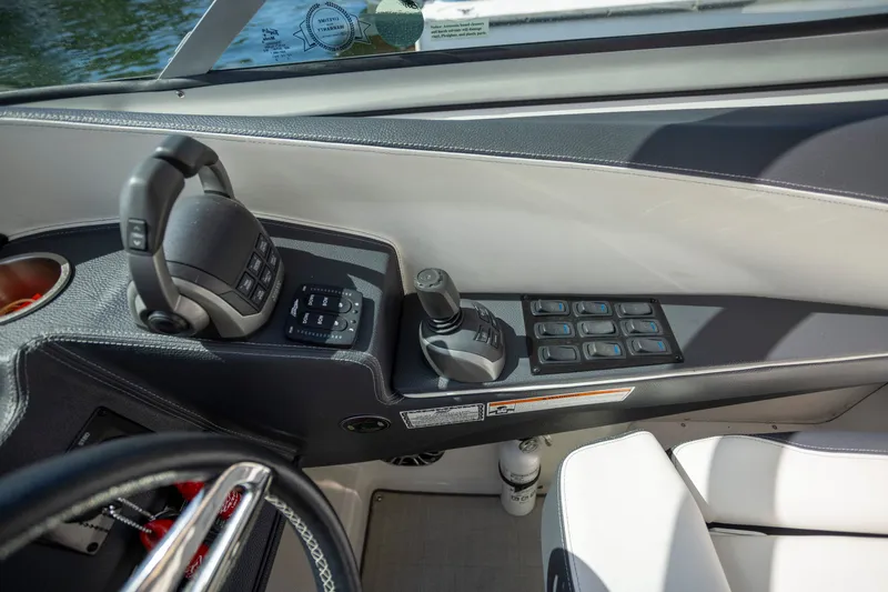 Slide: The Image of 2023 Regal 3300 Bowrider cockpit controls with joystick and switches. - 19