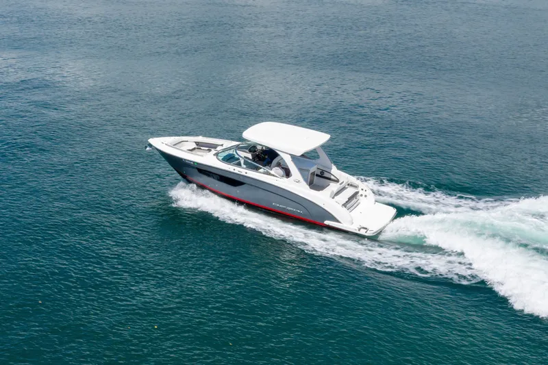 Slide: The Image of 2023 Regal 3300 Bowrider cruising on open water, showcasing sleek design and performance. - 6