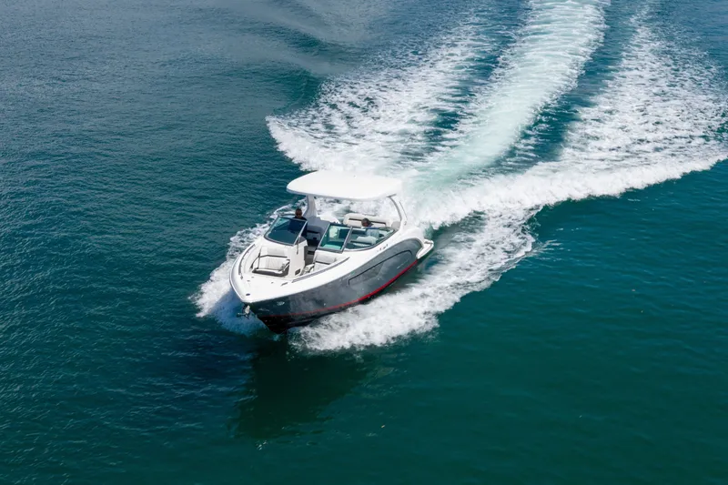 Slide: The Image of 2023 Regal 3300 Bowrider cruising on open water, leaving a wake trail. - 5