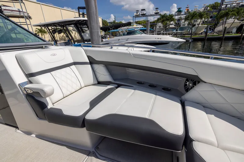 Slide: The Image of 2023 Regal 3300 Bowrider interior with luxurious seating at marina. - 25