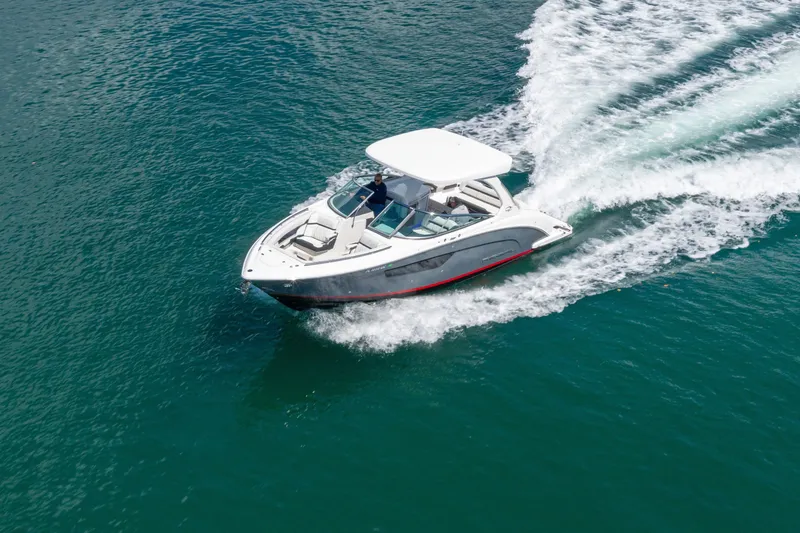 Slide: The Image of 2023 Regal 3300 Bowrider cruising on open water, showcasing sleek design and performance. - 4