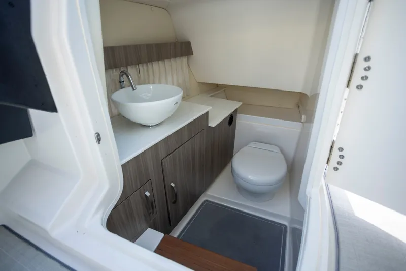 Slide: The Image of 2023 Regal 3300 Bowrider boat bathroom with modern sink and toilet. - 15