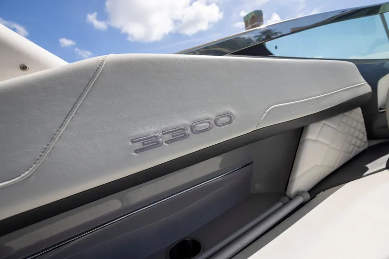 Slide: The Image of 2023 Regal 3300 Bowrider interior detail with logo, featuring sleek design and luxury upholstery. - 23