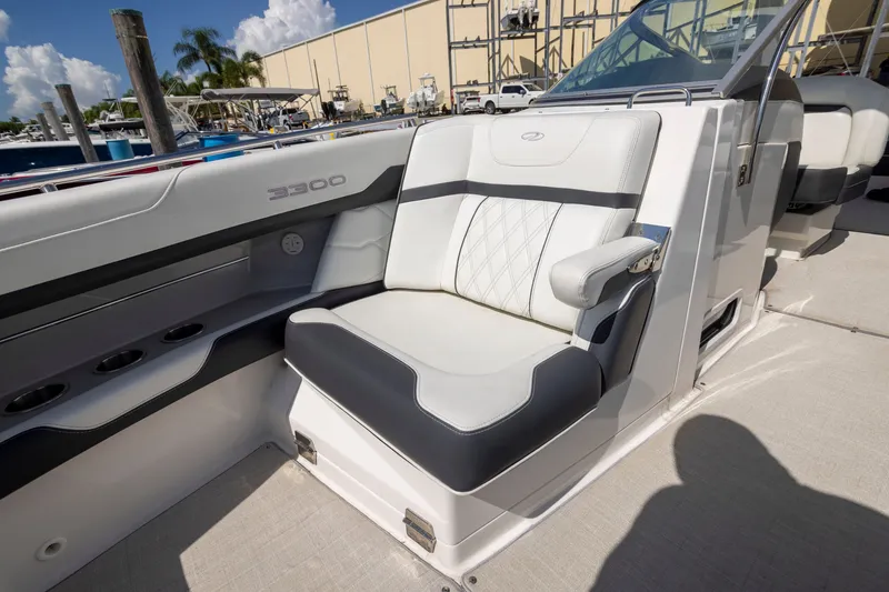 Slide: The Image of 2023 Regal 3300 Bowrider interior seating with luxurious white and black upholstery. - 24