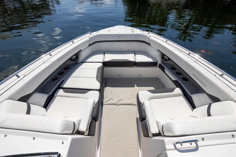 Slide: The Image of 2023 Regal 3300 Bowrider with spacious seating and elegant design on calm water. - 27