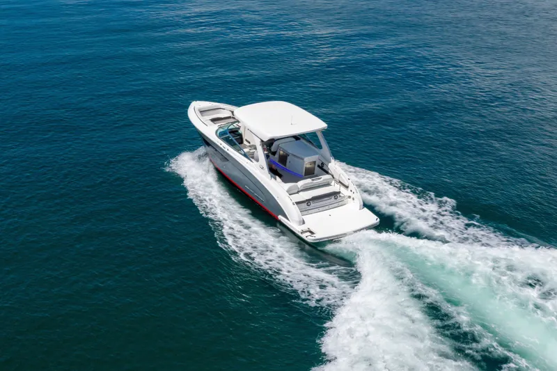 Slide: The Image of 2023 Regal 3300 Bowrider cruising on open water, showcasing sleek design and performance. - 7