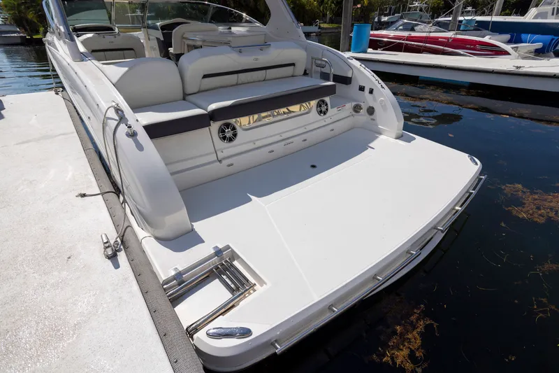 Slide: The Image of 2023 Regal 3300 Bowrider docked, showcasing spacious rear deck and seating area. - 28