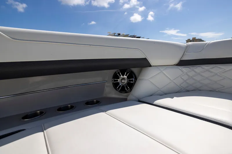 Slide: The Image of Luxurious seating on 2023 Regal 3300 Bowrider with premium speaker and quilted upholstery. - 26