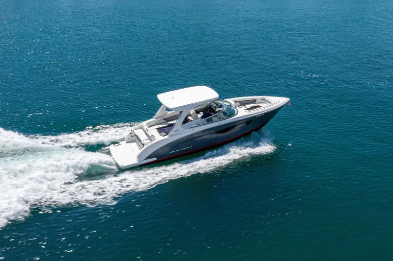 Slide: The Image of 2023 Regal 3300 Bowrider cruising on clear blue water. - 9
