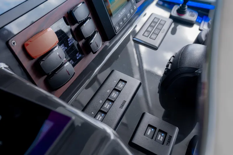 Slide: The Image of Control panel of 2022 Pursuit S 428 Sport boat with Yamaha controls and switches. - 23
