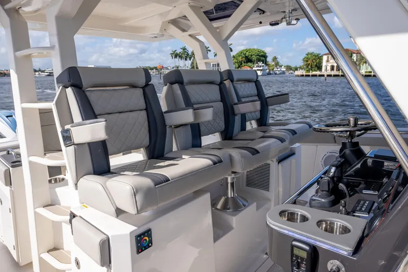 Slide: The Image of 2022 Pursuit S 428 Sport boat interior with luxurious seating and control panel. - 19