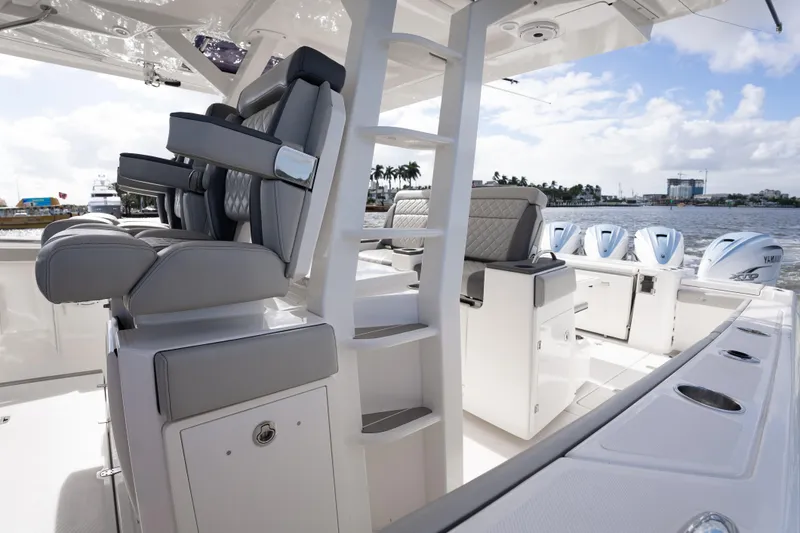 Slide: The Image of 2022 Pursuit S 428 Sport boat interior with luxurious seating and multiple Yamaha engines. - 30