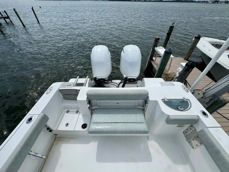 Slide: The Image of The image shows the stern of a 2019 Sportsman Open 252 Center Console boat with twin engines. - 13