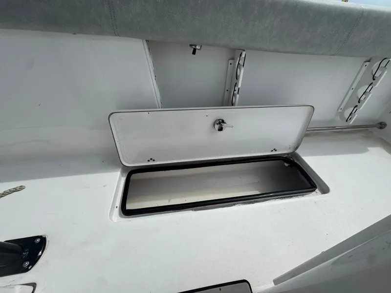 Slide: The Image of An open storage compartment on a 2019 Sportsman Open 252 Center Console boat. - 18
