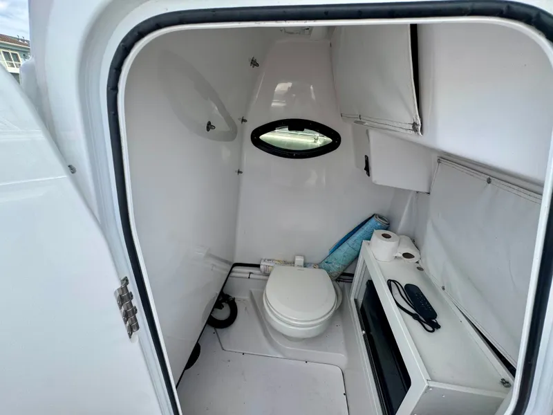 Slide: The Image of The image shows the interior of a boat's restroom with a toilet and a small window. - 22