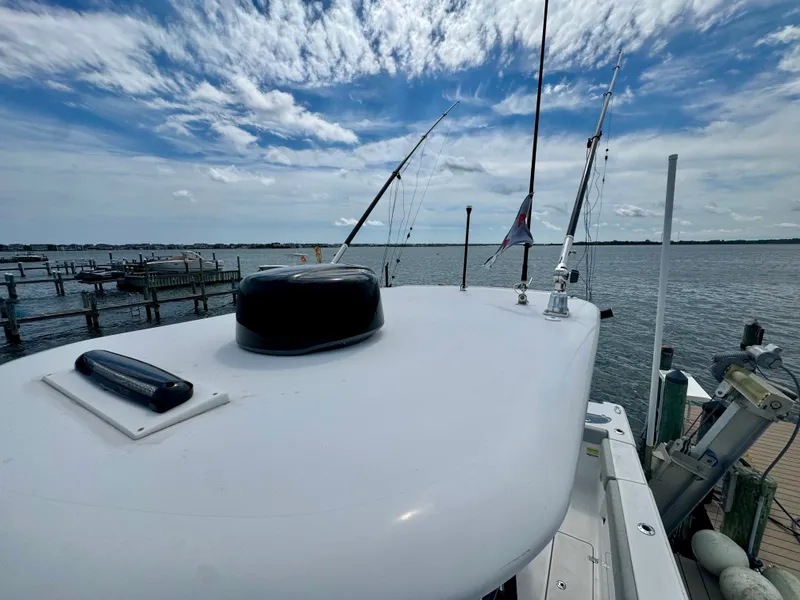 Slide: The Image of The image shows the deck of a 2019 Sportsman Open 252 Center Console boat overlooking the water. - 20