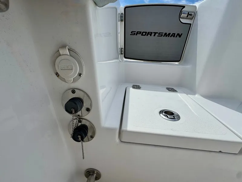 Slide: The Image of Close-up of a white boat deck with Sportsman logo and storage compartment. - 19