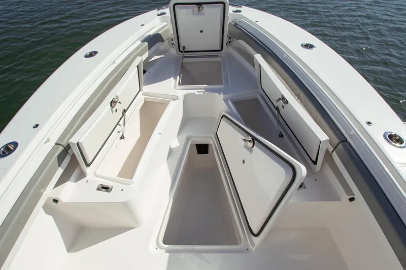 Slide: The Image of Manufacturer Provided Image: 2026 Regulator 25 boat with open storage compartments on deck. - 4