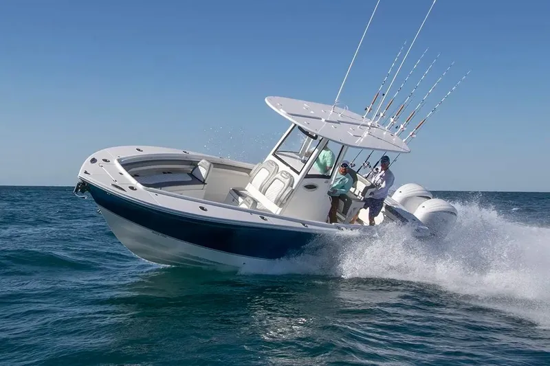 Slide: The Image of Manufacturer Provided Image: 2026 Regulator 25 boat cruising on open water with fishing rods. - 1