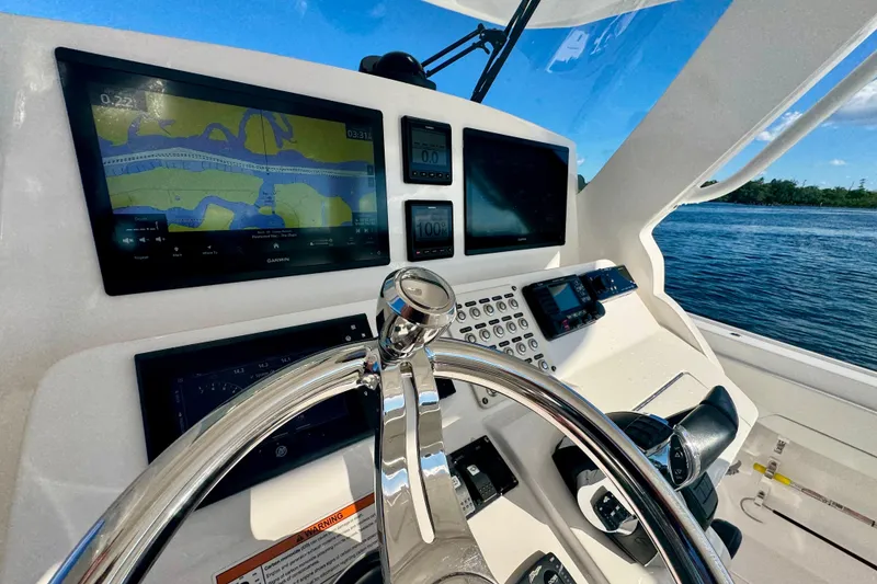 Slide: The Image of Cockpit of 2020 Intrepid 375 Nomad SE with navigation screens and steering wheel. - 28