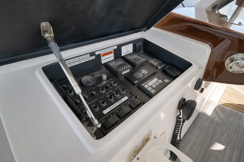 Slide: The Image of Control panel of a 2015 Hatteras GT70 yacht, featuring various gauges and switches. - 63
