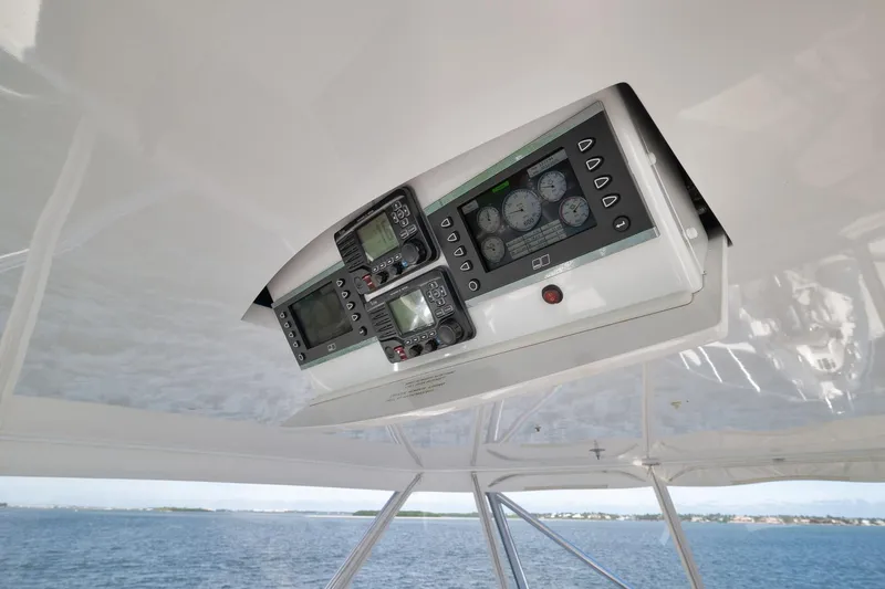 Slide: The Image of Control panel of 2015 Hatteras GT70 yacht, featuring navigation and monitoring instruments. - 75