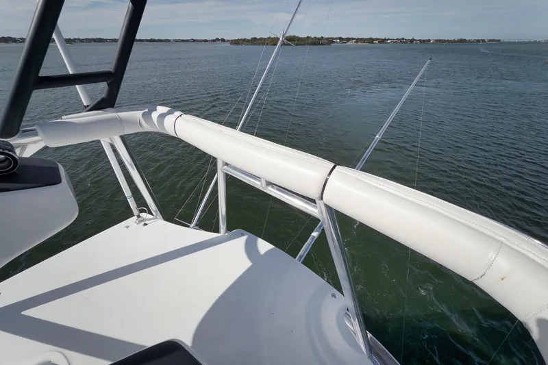 Slide: The Image of 2015 Hatteras GT70 yacht deck overlooking calm waters and distant shoreline. - 82