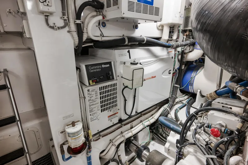 Slide: The Image of Engine room of 2015 Hatteras GT70 yacht featuring Cummins Onan generator and complex piping system. - 90