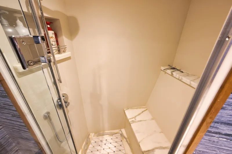 Slide: The Image of Luxurious shower in 2015 Hatteras GT70 yacht with marble bench and modern fixtures. - 47