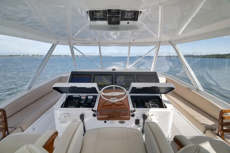 Slide: The Image of Helm of 2015 Hatteras GT70 yacht with advanced navigation systems and panoramic ocean view. - 62